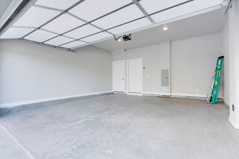 An empty room with a ladder in the corner